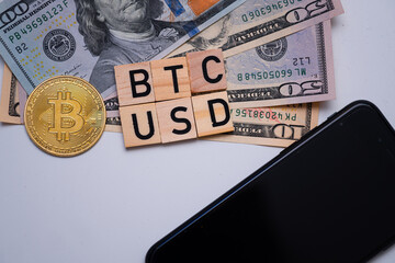 BTC USD inscription next to US dollars and bitcoin coin. Bitcoin dollar exchange rate. Drop in cryptocurrency prices