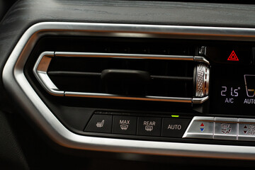 Windshield defrost button. Modern car interior details. Windshield heating close up view.