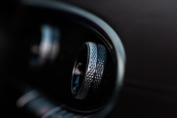 Fototapeta na wymiar Сlose up of a of chrome handle in modern car interior.