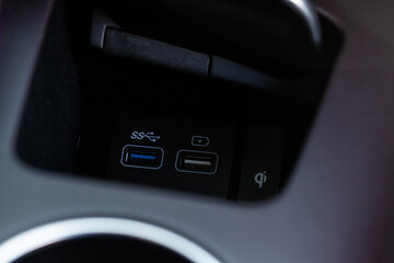 Opened car USB port in the car for connecting device. Power output of usb charger close up view. Car interior.