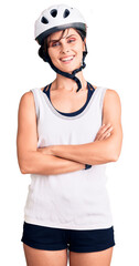 Beautiful young woman with short hair wearing bike helmet happy face smiling with crossed arms looking at the camera. positive person.