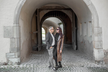 Fototapeta na wymiar love story of a loving couple.a couple - a girl and a guy walk and hug near the arch