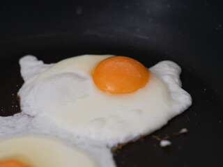 Two fried eggs in a frying pan