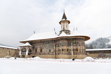 Sucevita, Romania, 2021-12-29. Sucevita Monastery in the Bukovina region under the snow. Their exterior walls are composed of frescoes painted in the 15th and 16th centuries, representing portraits of