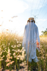 ghost standing around vegetation in broad daylight, at sunset, mexico