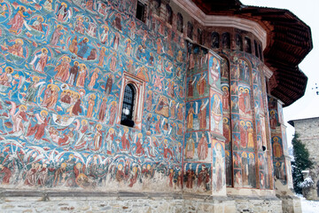 Moldovita, Romania, 2021-12-30. Moldovita Monastery, in the Bukovina region. Its exterior walls are...