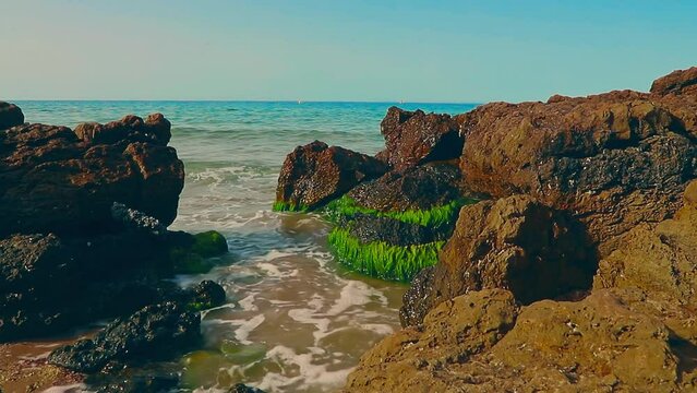 Waves hitting the rocks on the La Pineda beach in Salou Spain.