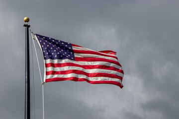 American flag flying on a cloudy day