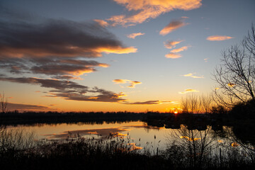Romania, 2022-01-01. Sunset on a lake in the Bucharest area.
