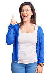 Young beautiful woman wearing casual clothes pointing finger up with successful idea. exited and happy. number one.