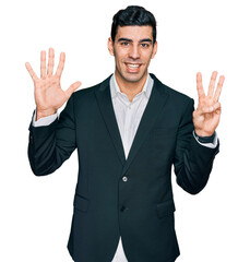Handsome hispanic man wearing business clothes showing and pointing up with fingers number eight while smiling confident and happy.