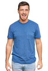 Obraz premium Handsome caucasian man wearing casual clothes winking looking at the camera with sexy expression, cheerful and happy face.