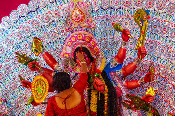 offering sweet to Goddess Durga at the day of "Vijaya Dasame".