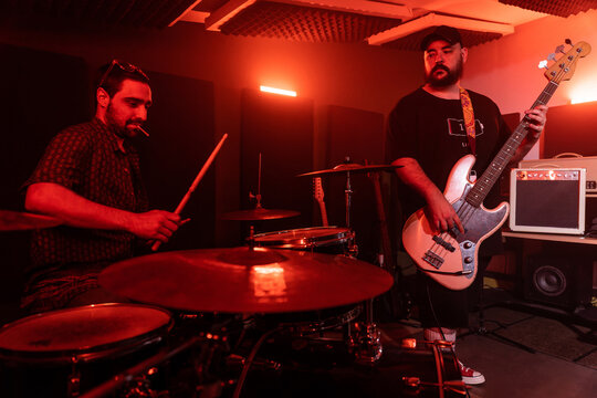 Male musicians performing music in studio