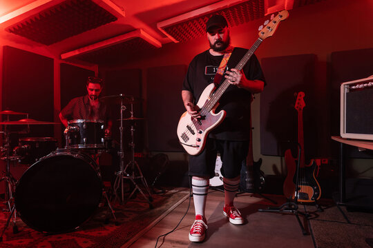 Male musicians performing music in studio