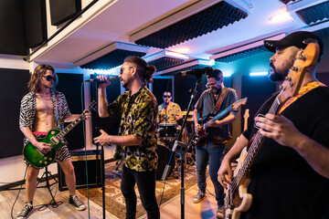 Band performing music in modern studio