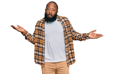 Young african american man wearing casual clothes clueless and confused expression with arms and hands raised. doubt concept.