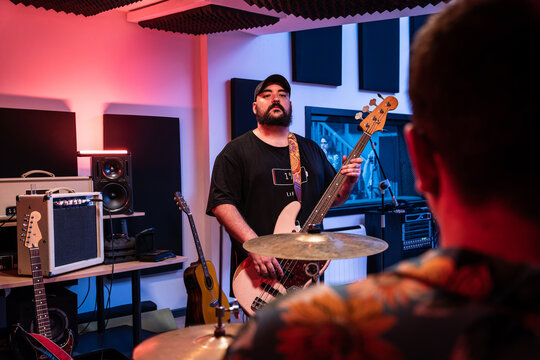 Male musicians performing music in studio - Powered by Adobe