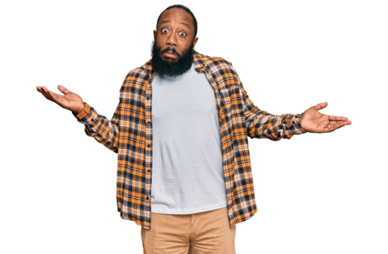 Young african american man wearing casual clothes clueless and confused expression with arms and hands raised. doubt concept.