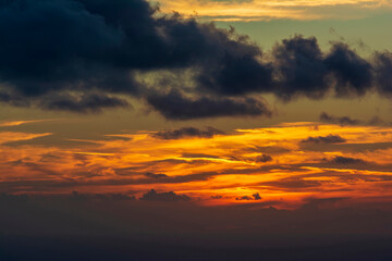 Dramatic colorful sunset sky with clouds over the sea