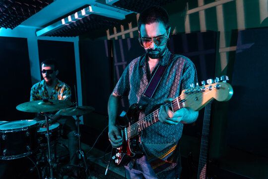 Male musicians performing music in studio