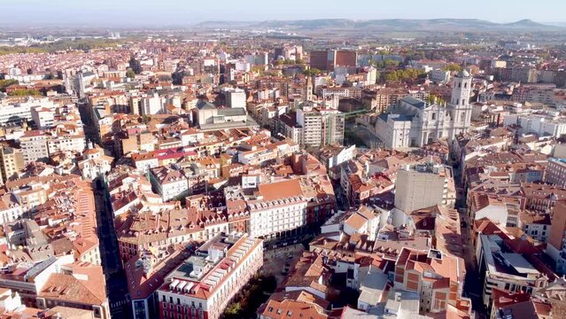 Aerial perspective of Valladolid - Spain. View of the city center and Cathedral of Valladolid in a foggy morning. Drone backward. Panoramic view of the city, rooftops and small streets. City skyline
