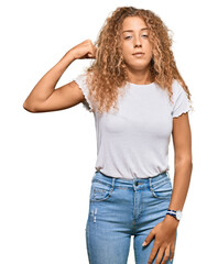 Beautiful caucasian teenager girl wearing casual white tshirt strong person showing arm muscle, confident and proud of power