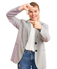 Young beautiful blonde woman wearing elegant jacket smiling making frame with hands and fingers with happy face. creativity and photography concept.