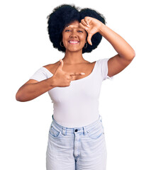 Young african american girl wearing casual clothes smiling making frame with hands and fingers with happy face. creativity and photography concept.