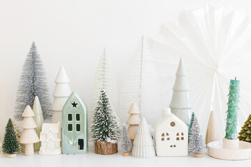 Merry Christmas and Happy Holidays! Modern christmas scene, miniature cozy snowy village. Stylish...