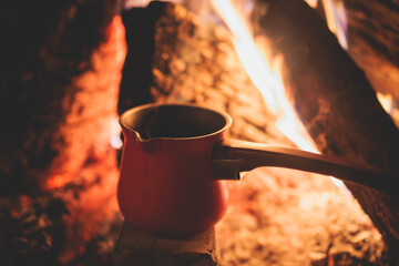 Warm by the fire, cozy winter night in the scandinavian cottage house cabin by the fireplace,...