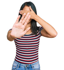 Beautiful asian young woman wearing casual clothes and glasses covering eyes with hands and doing stop gesture with sad and fear expression. embarrassed and negative concept.