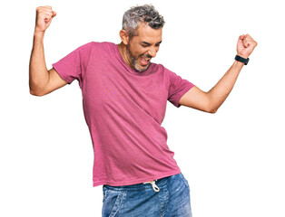 Middle age grey-haired man wearing casual clothes dancing happy and cheerful, smiling moving casual and confident listening to music