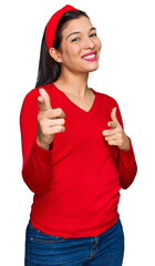 Young hispanic woman wearing casual clothes pointing fingers to camera with happy and funny face. good energy and vibes.