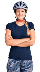 Beautiful caucasian woman wearing bike helmet happy face smiling with crossed arms looking at the camera. positive person.