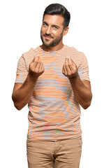 Handsome hispanic man wearing casual clothes doing money gesture with hands, asking for salary...