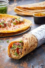 Shahi Korma paratha roll kathi shawarma wrap with dipping sauce isolated on background side view of...