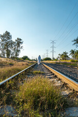 Fototapeta na wymiar ghost on train tracks with train passing behind, at sunset, mexico latin america