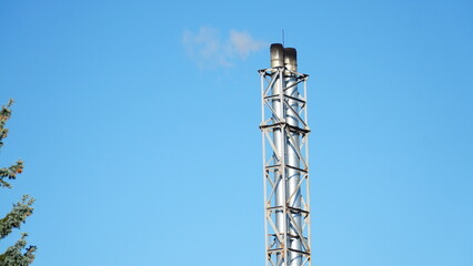 white smoke from the industrial pipe of the boiler room. Heating the house in winter. Heating with wood.