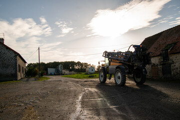 Sprayer on a farm during sunset Haute-Vienne, France
