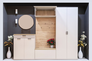 Modern hallway interior with stylish furniture, round mirror and wooden hanger on gray wall