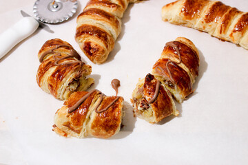 Baking in the form of a bagel with a filling inside of a whole banana and chocolate.