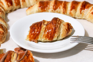 Baking in the form of a bagel with a filling inside of a whole banana and chocolate.