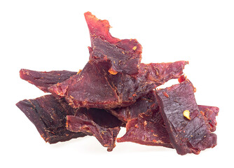 Pile of dried jerky beef meat isolated on a white background. Spiced beef jerky.