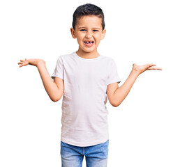 Little cute boy kid wearing casual white tshirt celebrating victory with happy smile and winner...