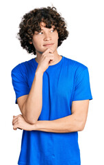 Caucasian teenager wearing casual clothes with hand on chin thinking about question, pensive...