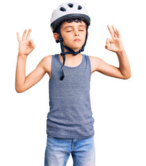 Little cute boy kid wearing bike helmet relax and smiling with eyes closed doing meditation gesture with fingers. yoga concept.