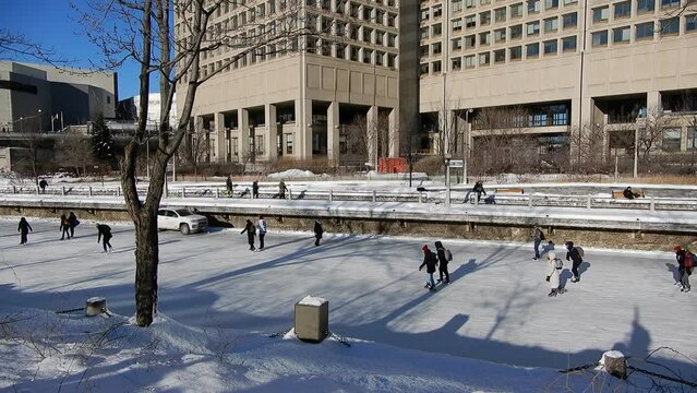 People Skating On Ice On Irdeau Canal In Downtown Ottawa Canada