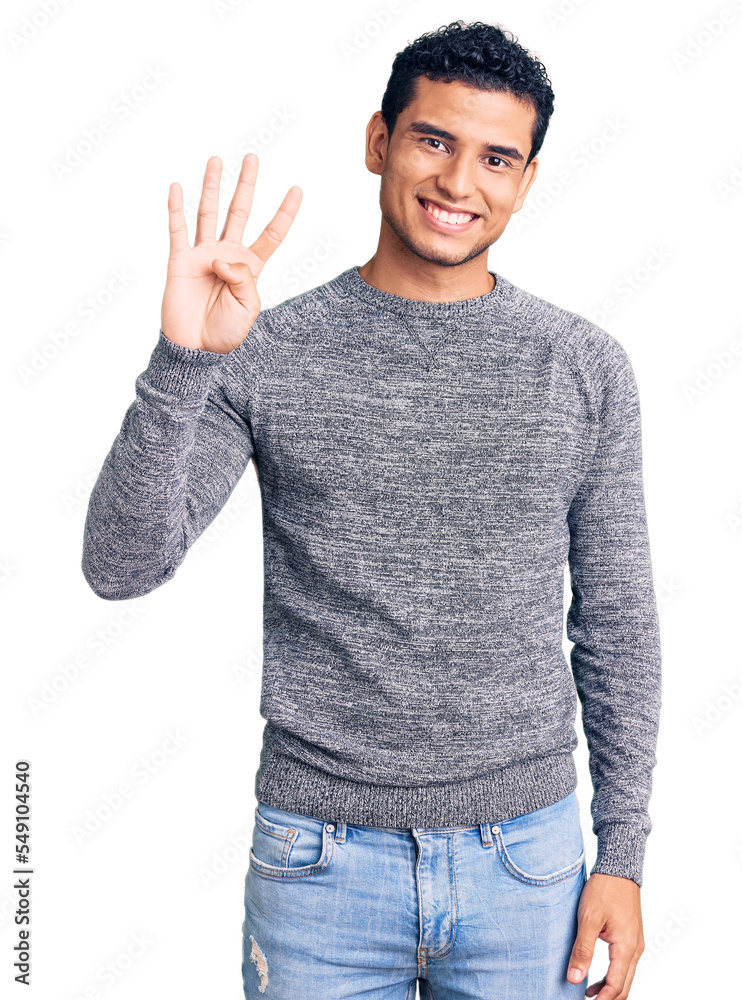 Sticker Hispanic handsome young man wearing casual sweater showing and pointing up with fingers number four while smiling confident and happy.