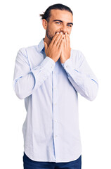 Young handsome man wearing business clothes laughing and embarrassed giggle covering mouth with...